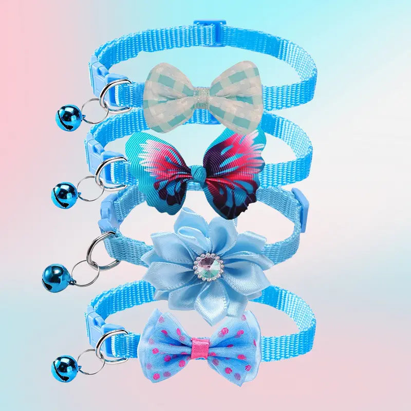 Set of four adjustable blue bow cat collars with bell featuring decorative bow and flower charms.