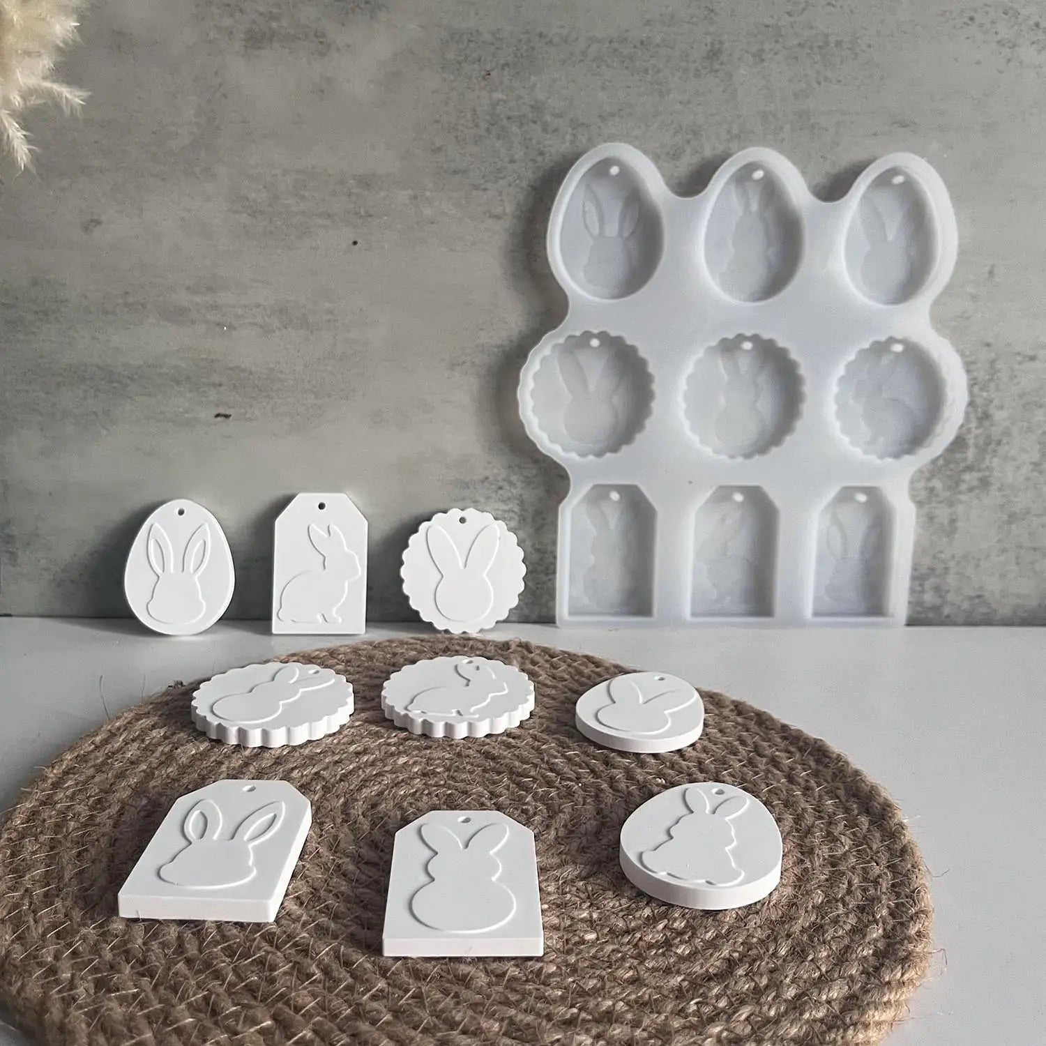 white silicone easter egg and bunny-shaped molds with tag designs for making resin pendants in the easter bunny silicone resin pendant mold set.