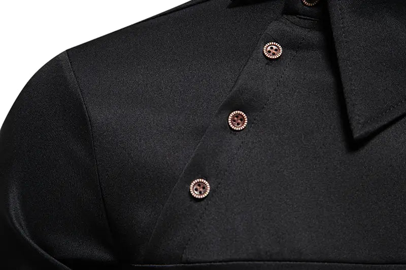 Men asymmetrical slant collar long sleeve casual black satin shirt with decorative rose gold buttons.