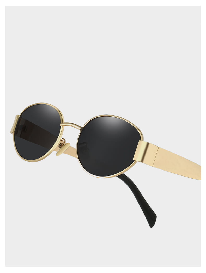 Gafas de sol ovaladas para mujer y hombre con montura metálica redonda en tono dorado, lentes oscuros y un diseño minimalista y elegante.