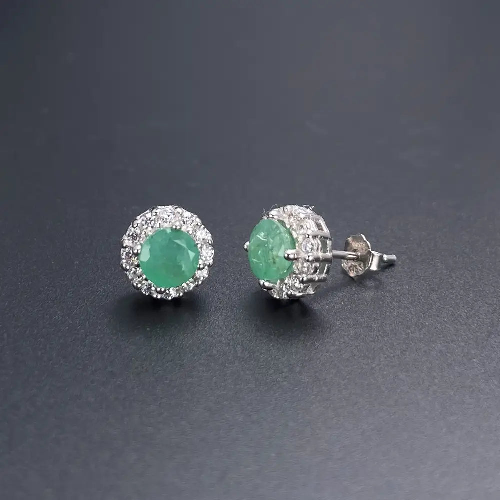 A pair of elegant stud earrings featuring vibrant green jade stones surrounded by a halo of sparkling clear diamonds set in polished sterling silver from the emerald sterling silver jewelry set.