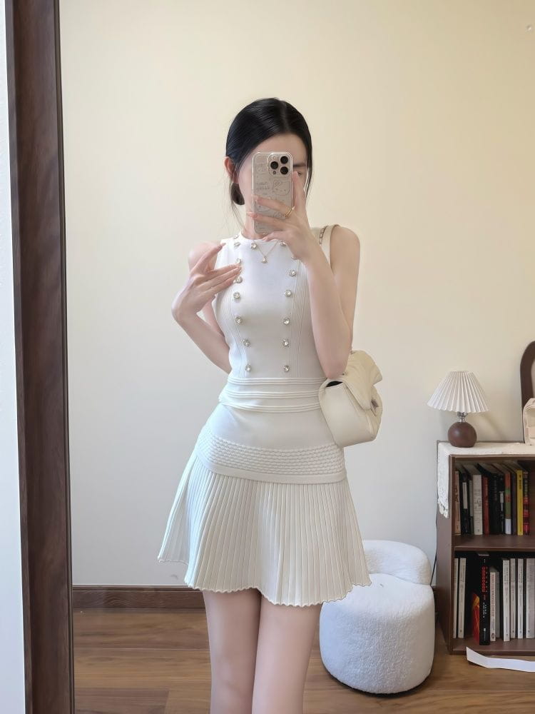white sleeveless knit tank top and pleated skirt set with pearl embellishments made of knit fabric featuring a length of 40cm and a back zipper closure suitable for elegant occasions