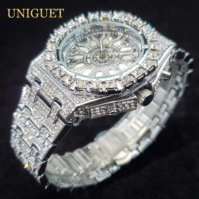A dazzling silver iced diamond men’s quartz watch featuring a diamond-encrusted ornate face and an intricate bracelet design for a luxury hip hop timepiece.