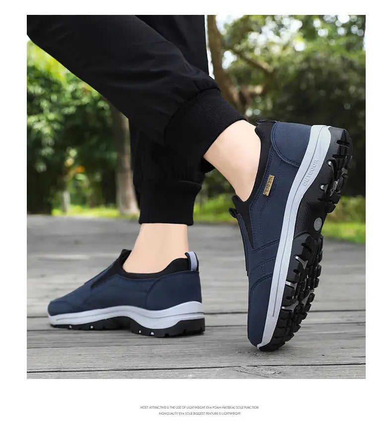 Men orthopedic slip-on walking shoes in navy blue featuring a breathable mesh upper, white midsole, black outsole, and padded collar for enhanced comfort.