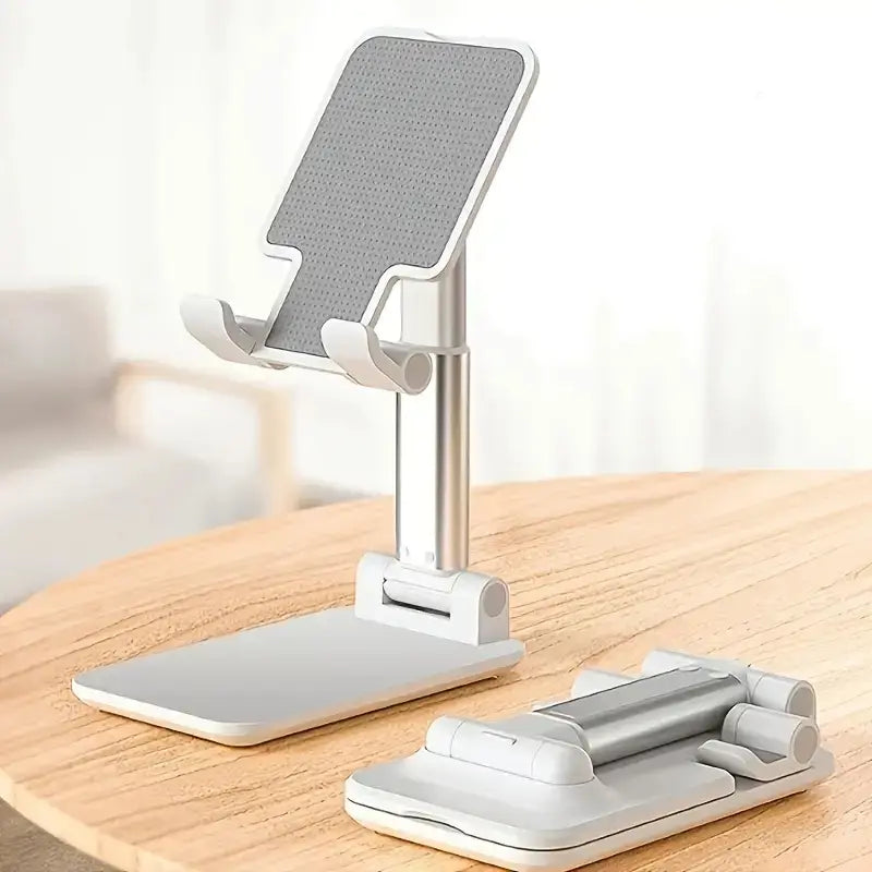 Support réglable pour téléphone de bureau et tablette en argent, avec un cadre pliable blanc et une surface de préhension grise texturée.