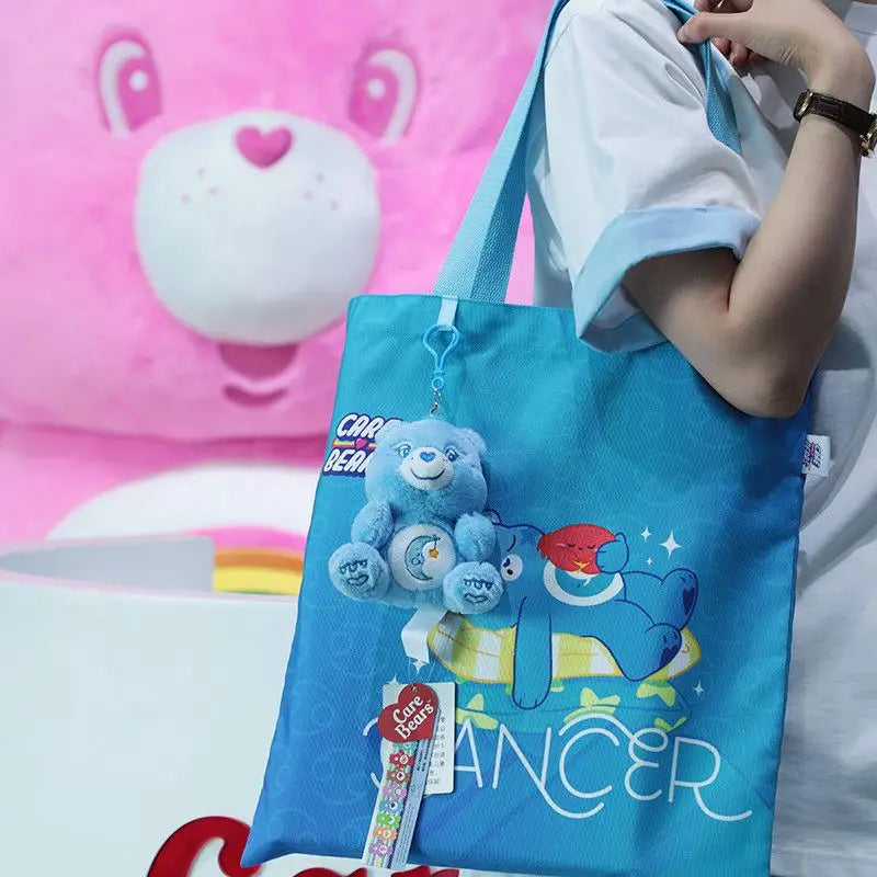 Blue Care Bears tote bag featuring a plush bear charm and printed design used as a plush bag pendant keychain toy.