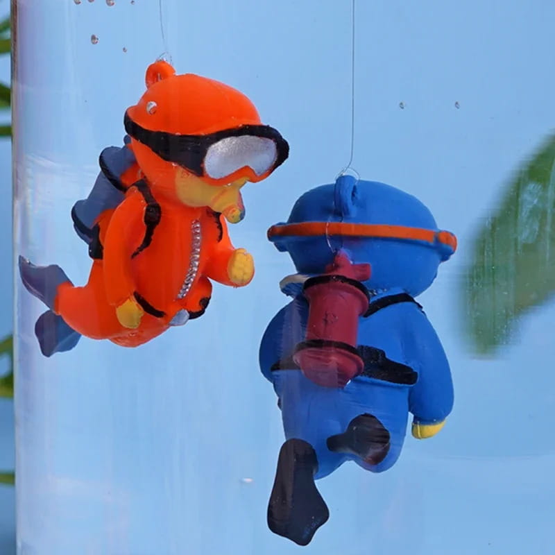 Two colorful plastic diving bear figurines in bright orange with black goggles and a red oxygen tank and in blue with an orange headband carrying a pink fire hydrant for popular aquarium decorations fish tanks landscape decor accessories gifts for aquatic pets.