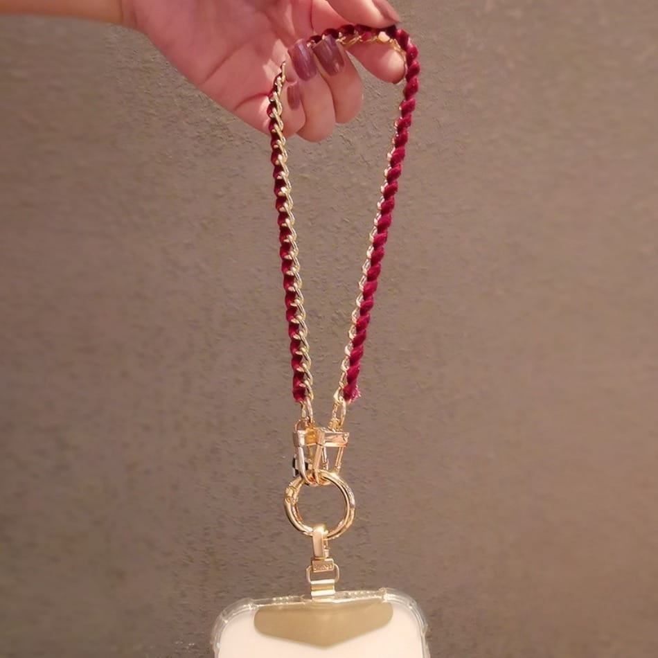 Ein roter geflochtener Kord-Handy-Handgelenkriemen mit goldfarbenen Metall-Verschlüssen und einem Ring, gestaltet als Anti-Lost-Handylanyard für Handyhüllen oder Taschen.