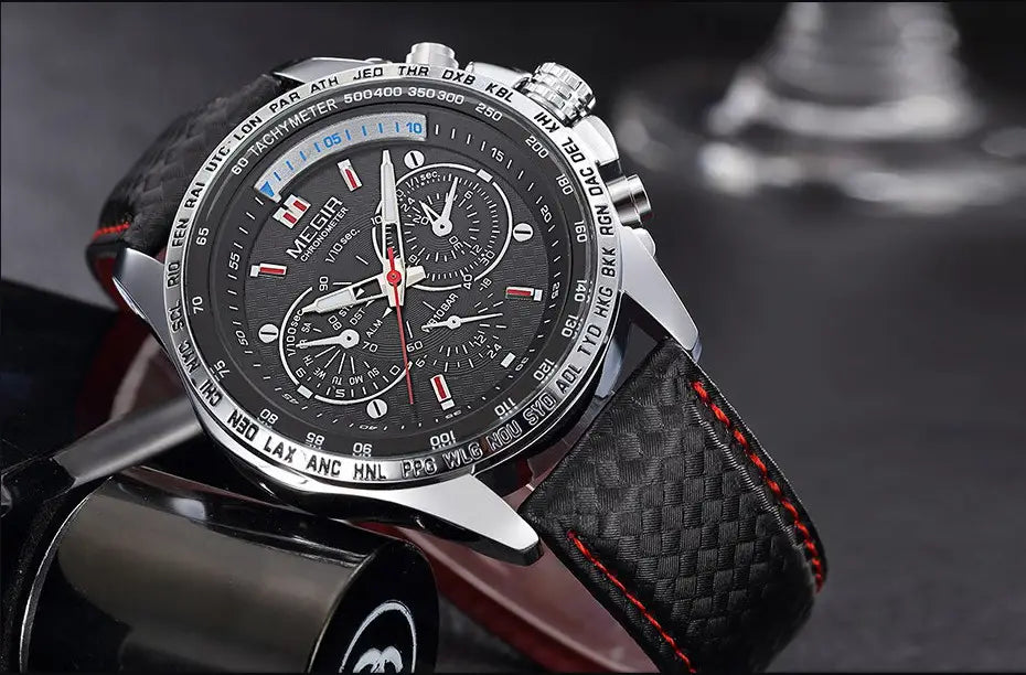 A sleek black and silver Megir 1010 men quartz chronograph watch with a carbon fiber strap accented by red stitching.