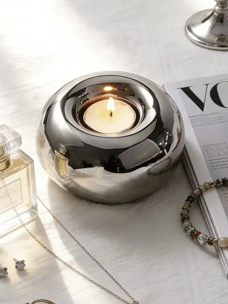 Silver ceramic sphere candle holder with a shiny silver metallic finish featuring a smooth rounded design and reflective surface.