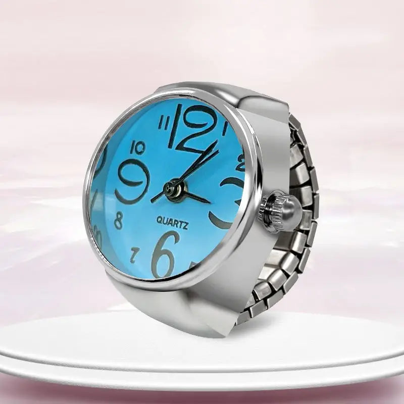 Silver-toned quartz ring watch with a bright blue face and black arabic numerals designed as finger couple jewelry.