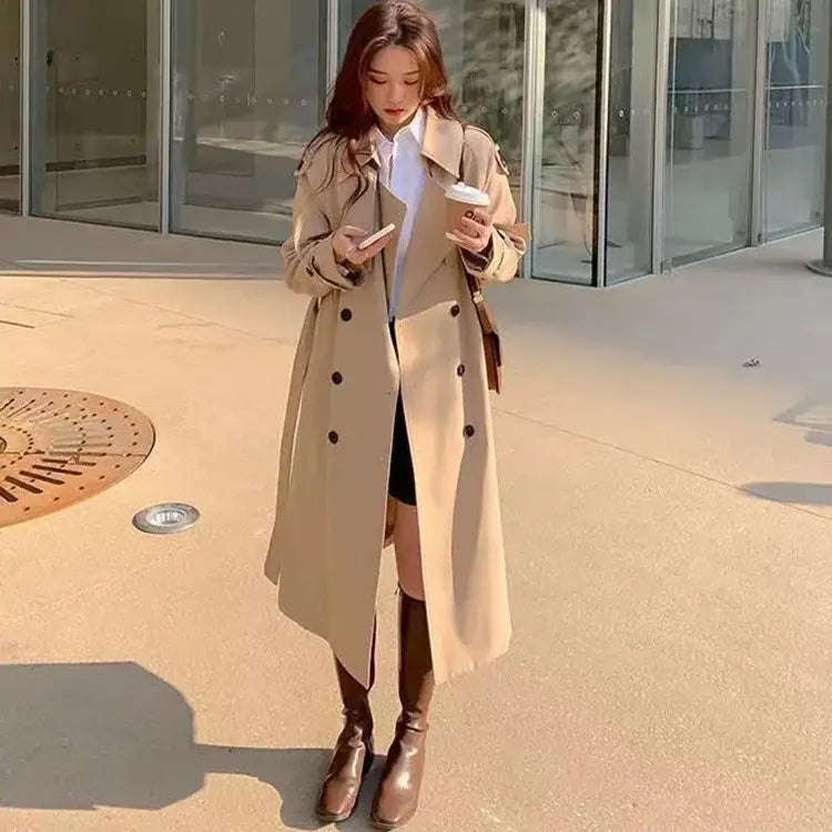 Beige double-breasted trench coat with classic military-inspired design for women casual windbreaker use.