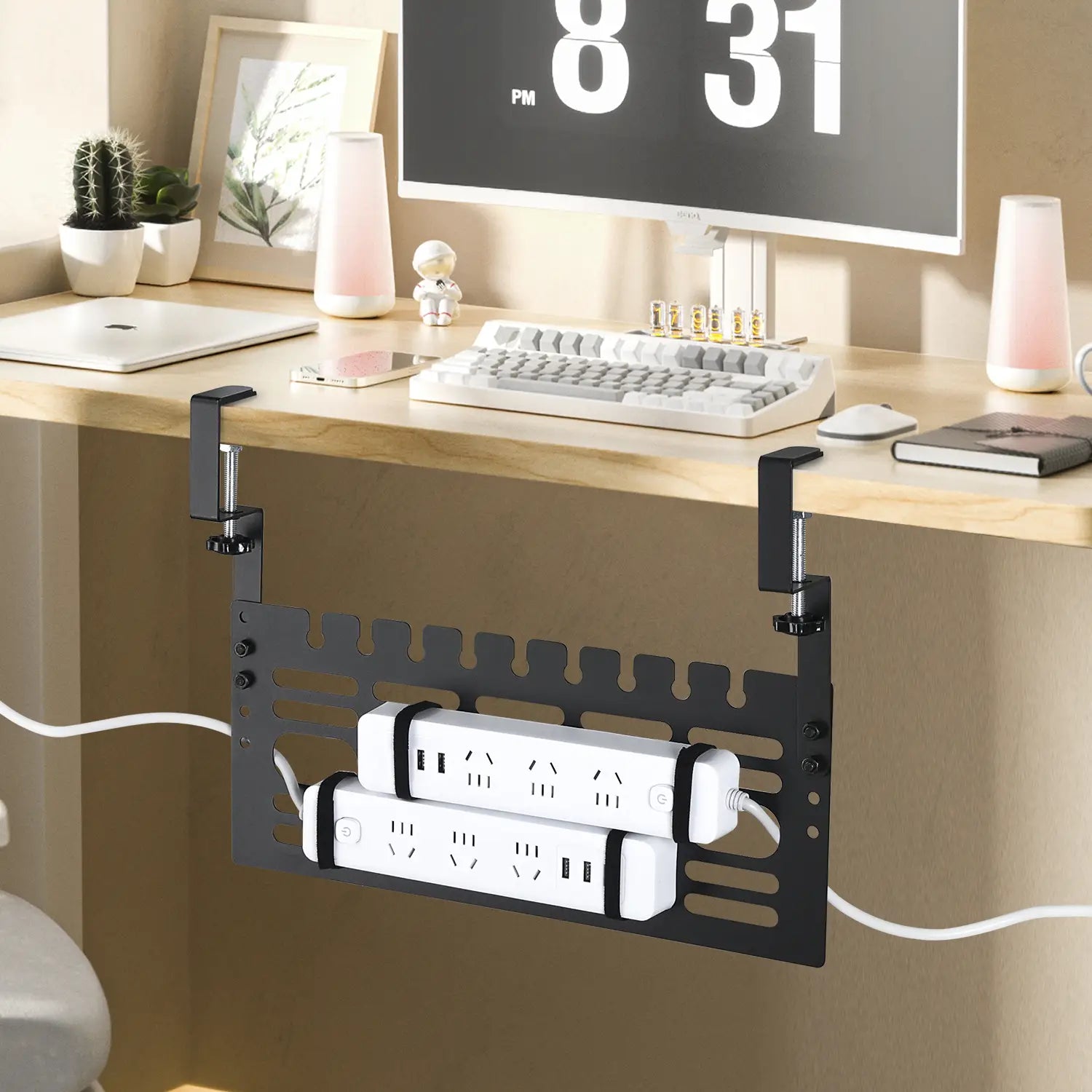 Black metal desk-mounted power strip organizer with two white surge protectors secured inside designed for under desk cable management.
