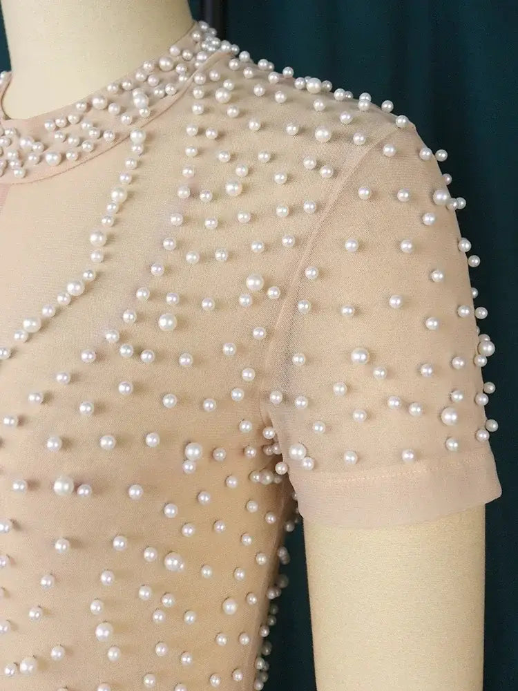 Beaded high waisted jumpsuit featuring a delicate beige mesh top adorned with evenly spaced lustrous white pearls along the neckline and shoulders ideal for elegant party outfits.