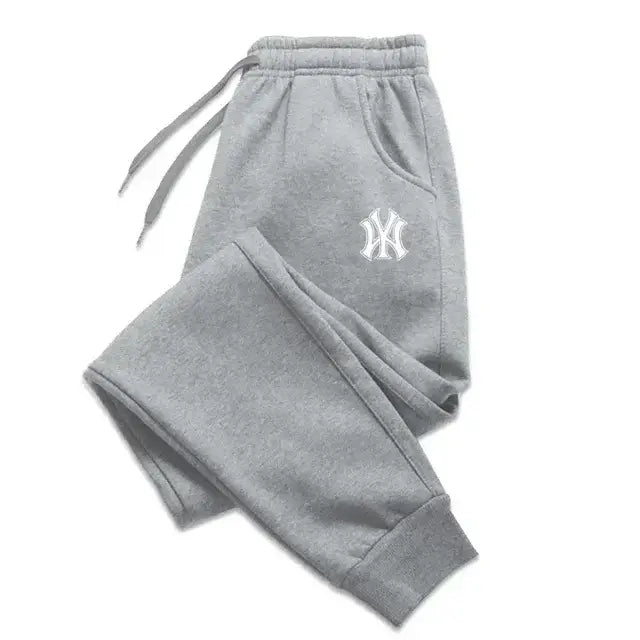 Sudaderas tipo jogger de felpa para hombre de Yankees en felpa jaspeada gris con un logotipo bordado de NY en color blanco en el muslo.