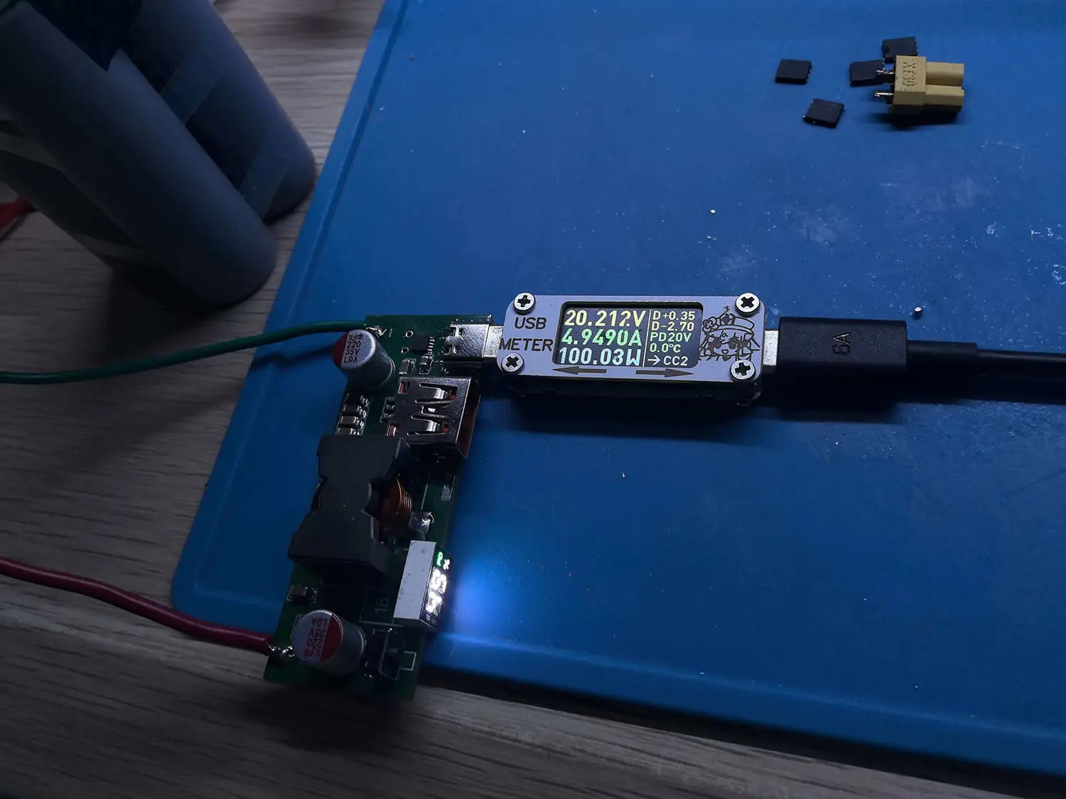Black USB power meter with digital display showing voltage current and wattage readings for 100w Pd3.1 fast charger power bank module BMS.