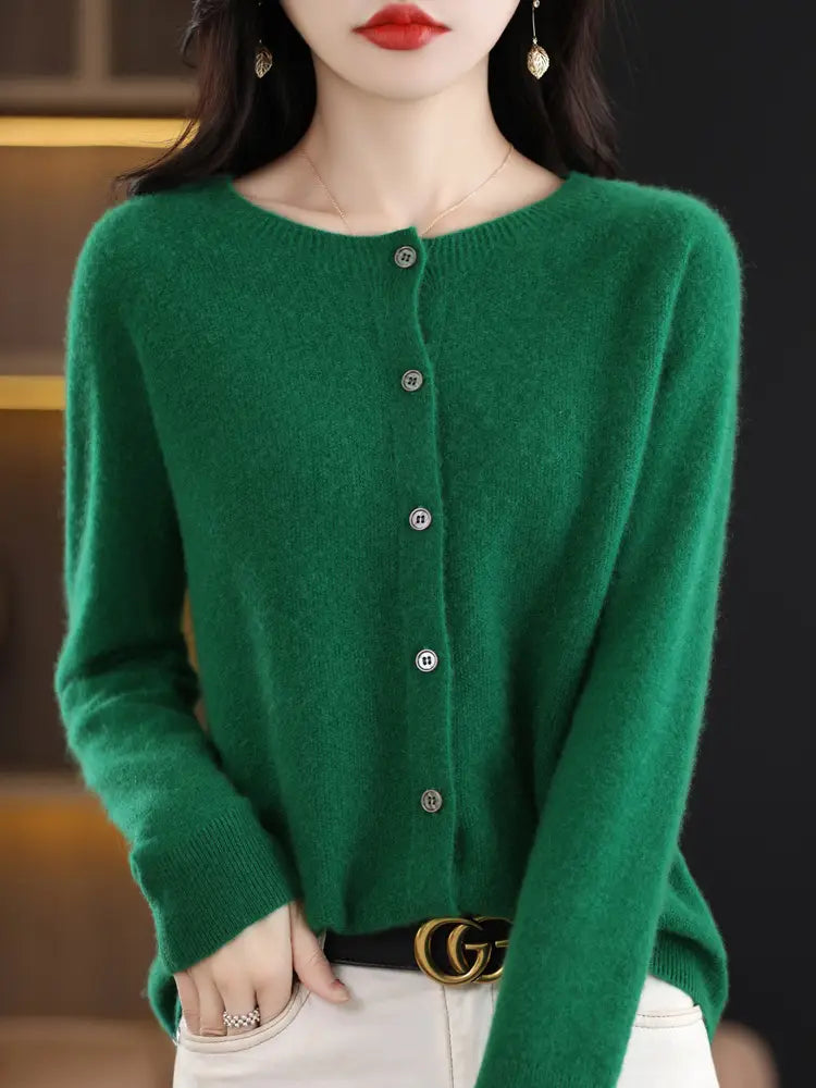A soft emerald green merino wool cardigan for women with a round neckline and silver buttons.