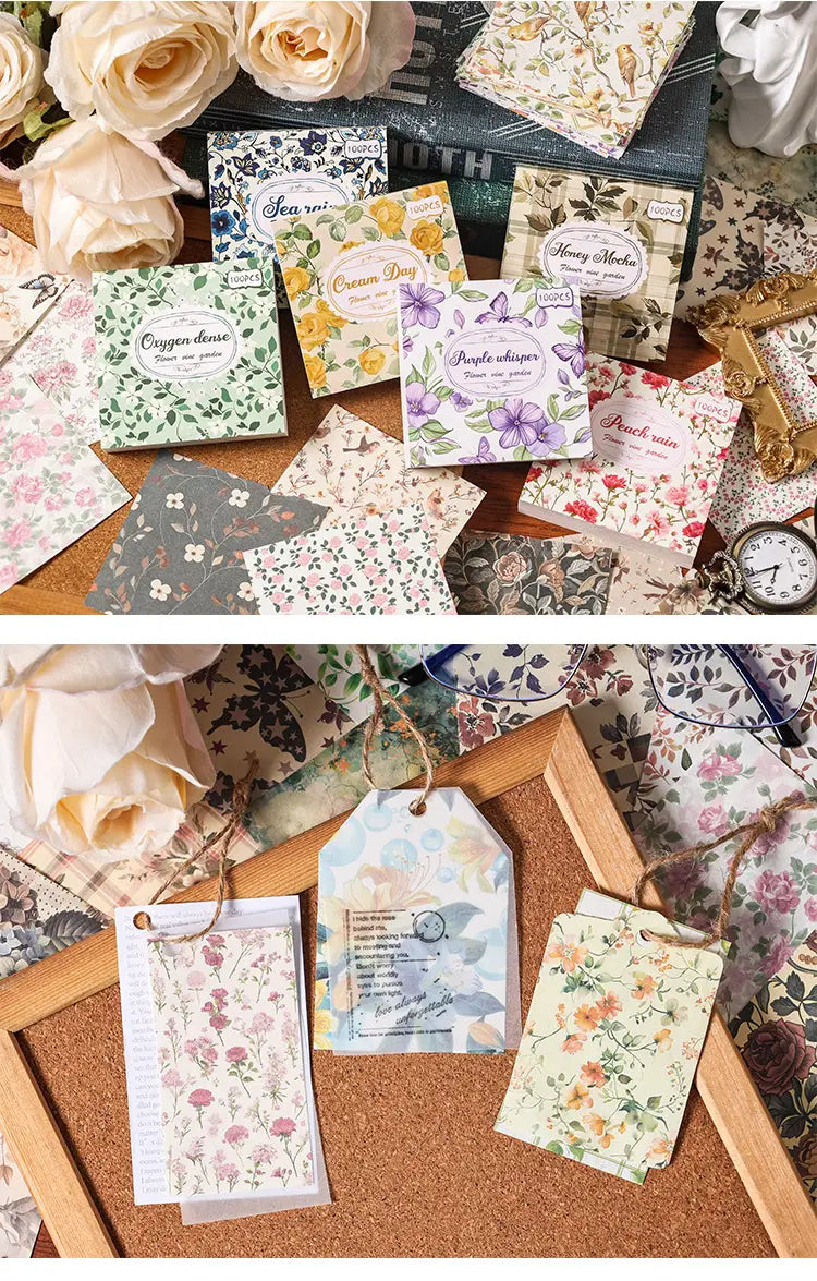 a collection of vintage scrapbooking paper and journaling supplies featuring delicate floral-patterned tags and decorative envelopes in soft pastel hues on textured cardstock with intricate botanical designs.