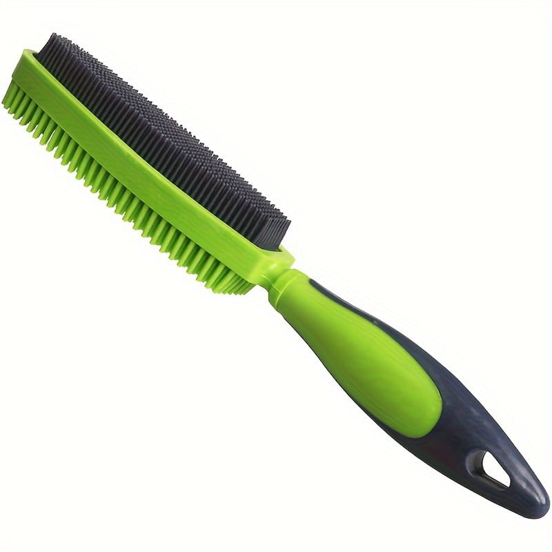Silicone pet hair remover brush showing the back side featuring a green and black dual-sided design with an ergonomic handle for effective grooming.