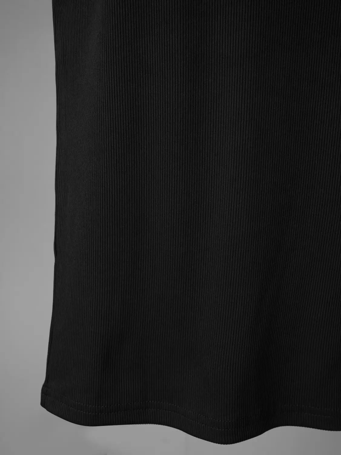 Black ribbed fabric with a textured vertical-striped pattern featured on a men’s ribbed square neck tank top.