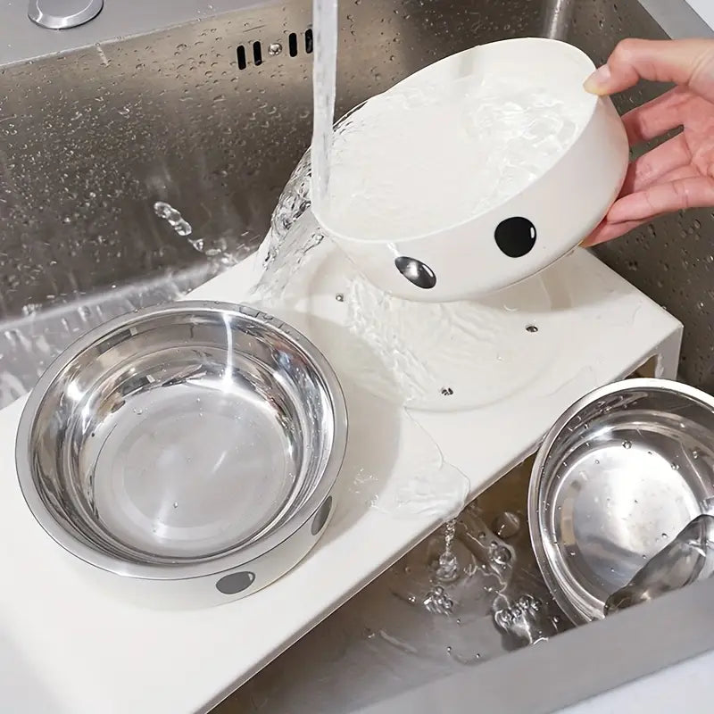 white ceramic pet bowl with black and silver circular accents featured in an elevated dog feeder raised stand with stainless steel bowls designed for comfortable feeding.