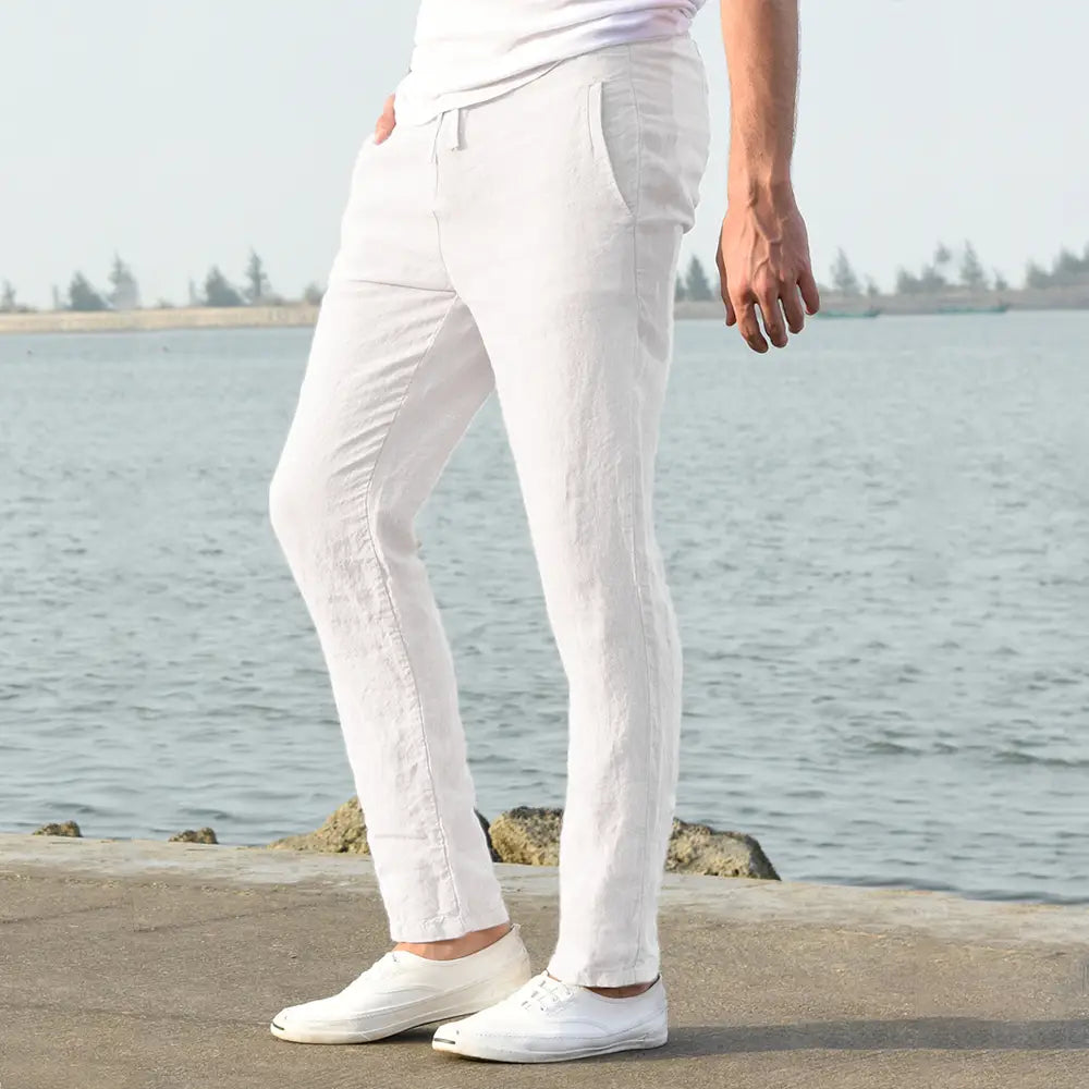 men cotton linen trousers in white featuring a relaxed fit and subtle side seam detailing for breathable casual wear