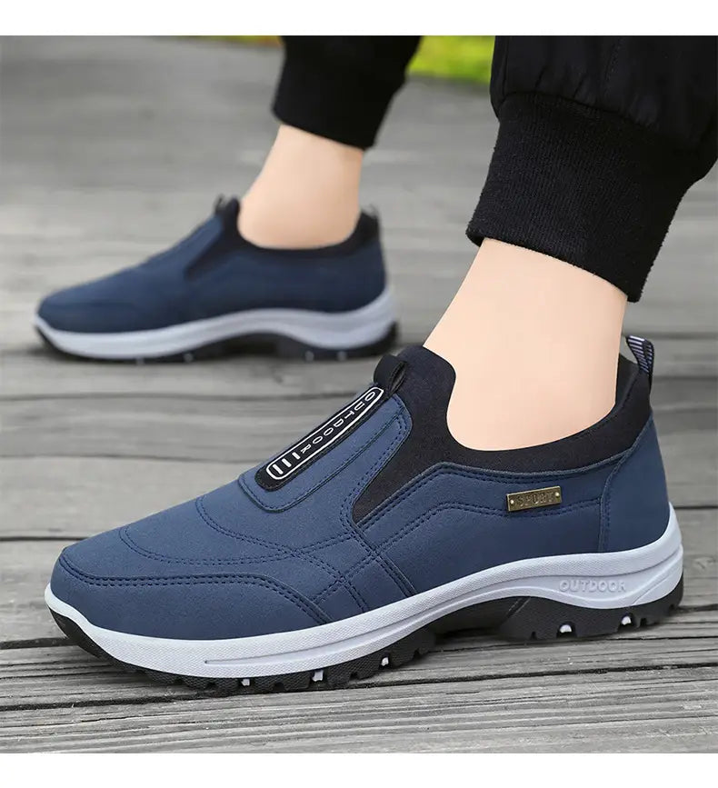 Navy blue slip-on orthopedic walking shoe for men with black accents and white midsole designed for comfortable athletic use.