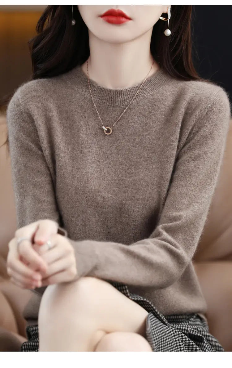 a soft taupe-colored pure wool cashmere o-neck pullover sweater with long sleeves and ribbed cuffs