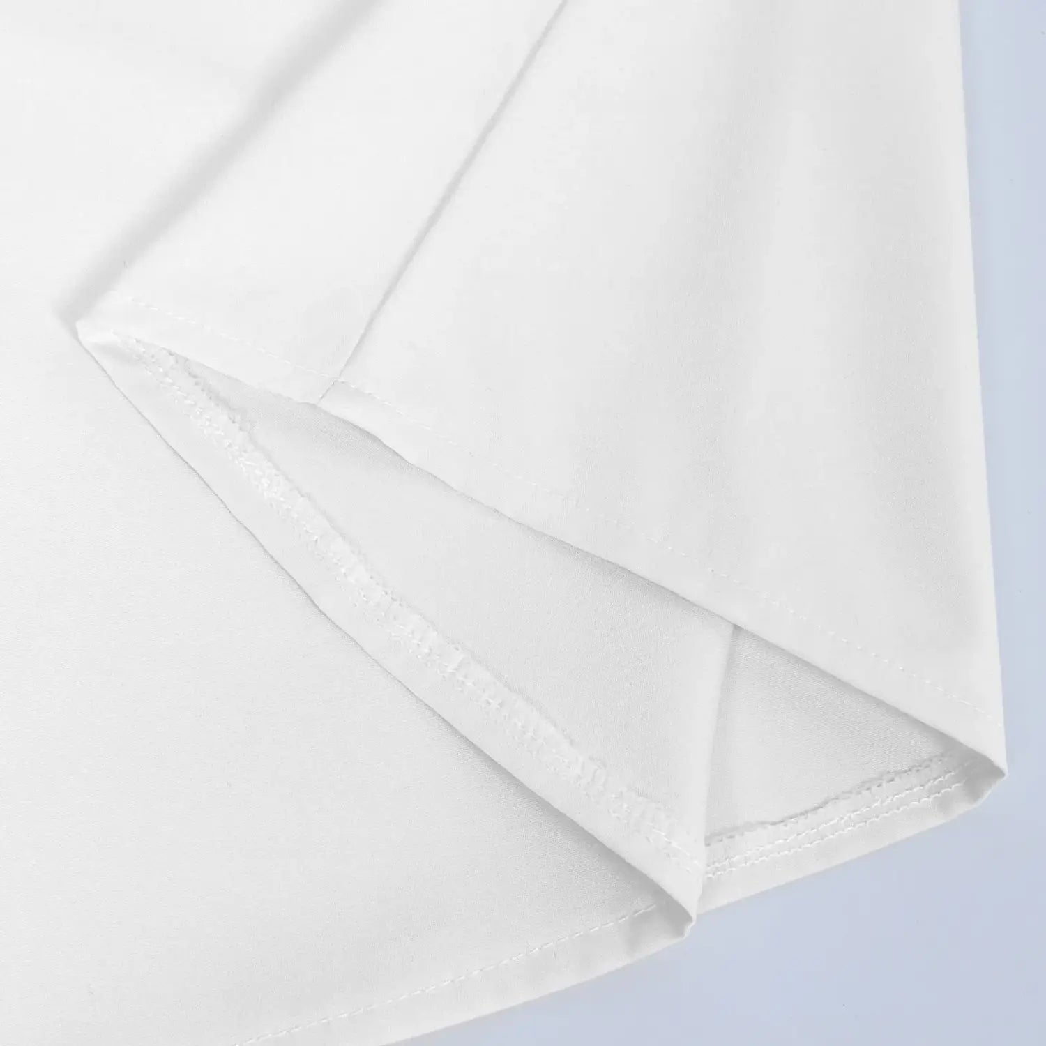 White cotton fabric detail showing neat fine stitching along the folded edge of a mens pirate medieval renaissance lace up shirt by arba global.