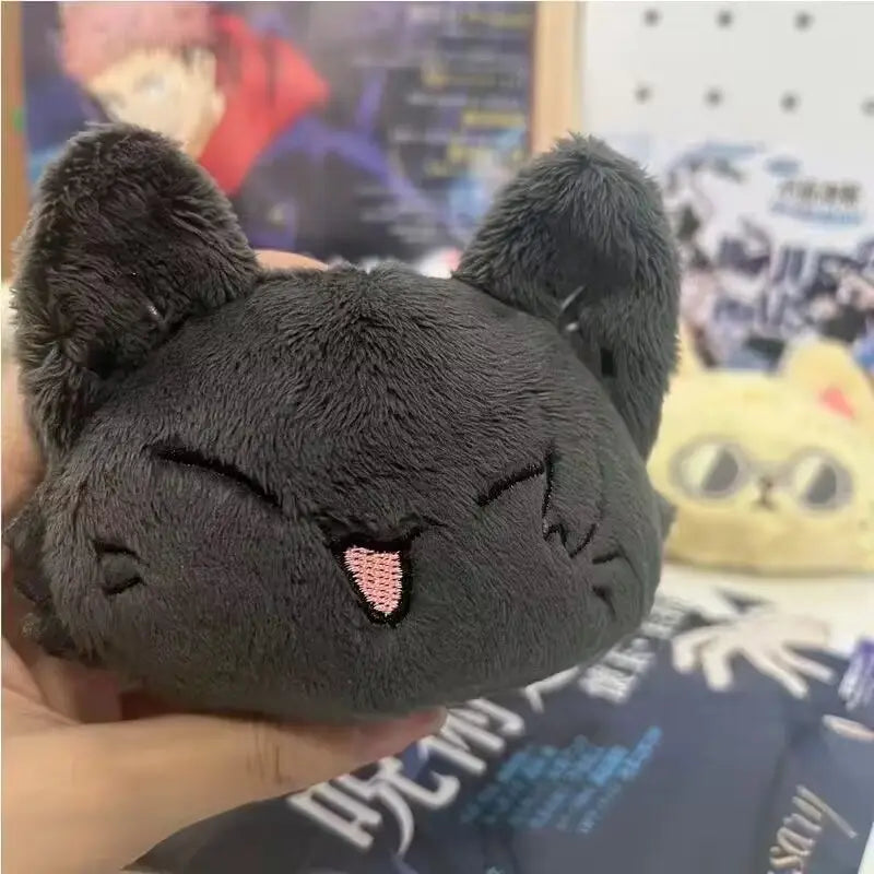 A soft dark gray plush Gojo and Geto cat anime keychain featuring embroidered pink cheeks and closed eyes.