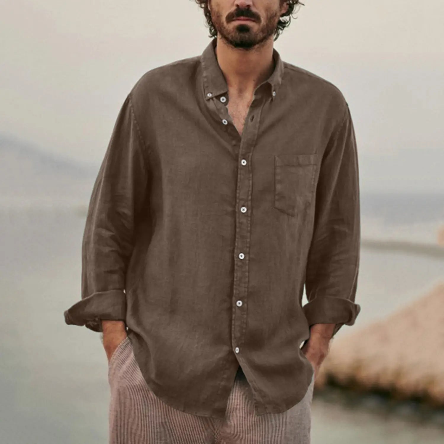A men linen blend casual shirt in muted olive with relaxed fit, chest pocket, and rolled-up sleeves made of linen.