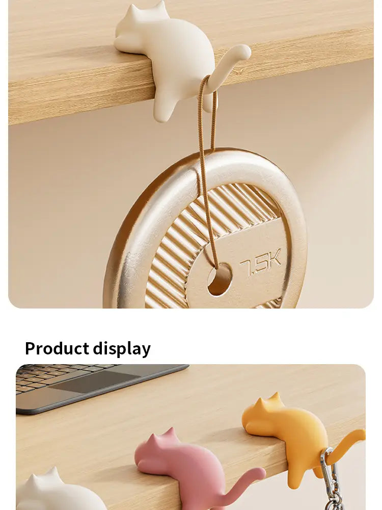 A charming white ceramic cat-shaped desk hook with a smooth glossy finish and delicate tail detail designed as a silicone organizer.