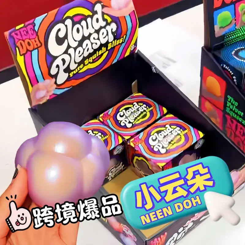 a soft translucent purple and peach gradient needoh cloud pleaser squishy toy with a cloud-like segmented design viewed from the front