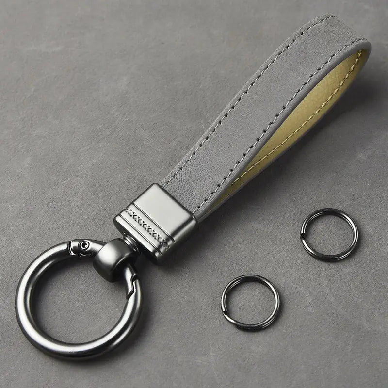 Gray suede leather keychain with silver-toned metal clasp and contrasting yellow stitching from the multicolor metal clasp set