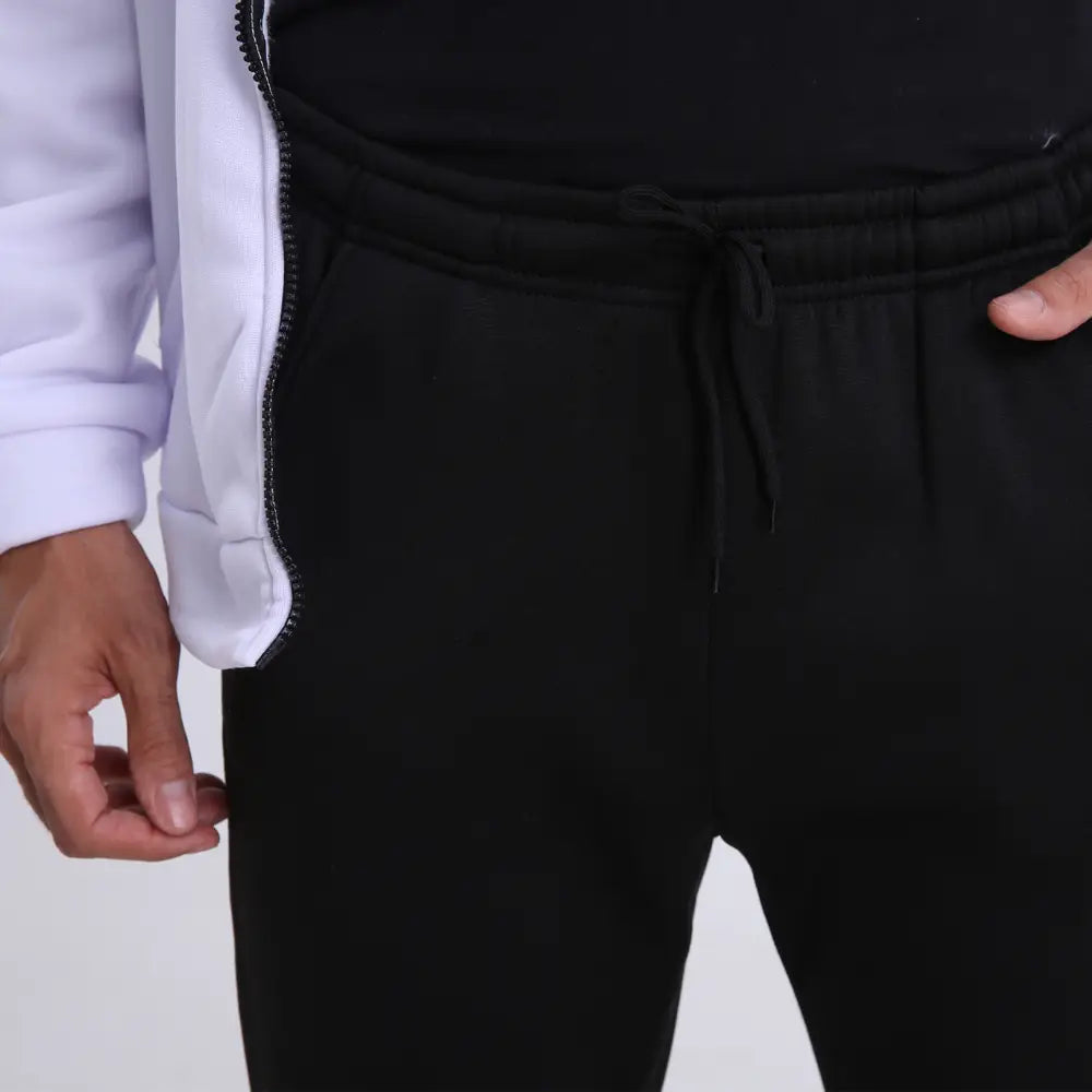 エラスティックウエストとサイドポケット付きの黒のドローストリングスウェットパンツに、メンズポルカドットジップアップフーディーを組み合わせました。