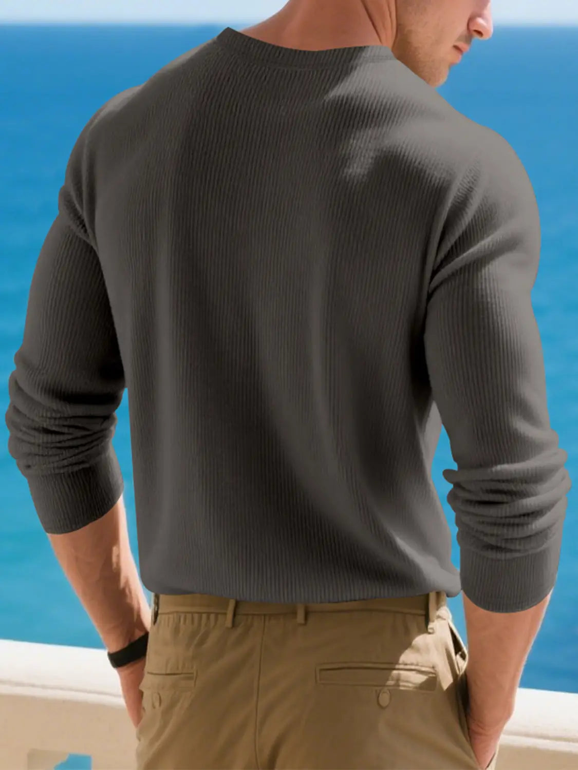 A dark gray ribbed knit long-sleeve henley shirt for men designed as a casual top.