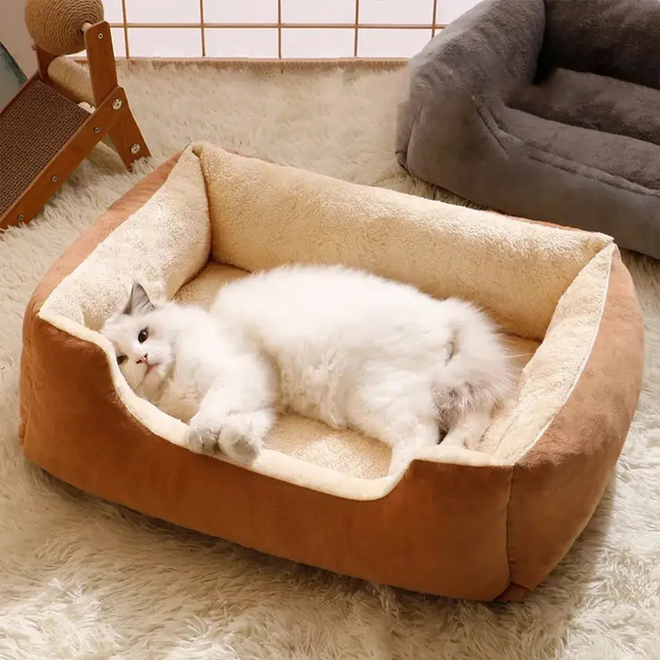 Cozy tan and cream plush rectangular cat bed with soft cushioned edges designed as a soft pet basket.