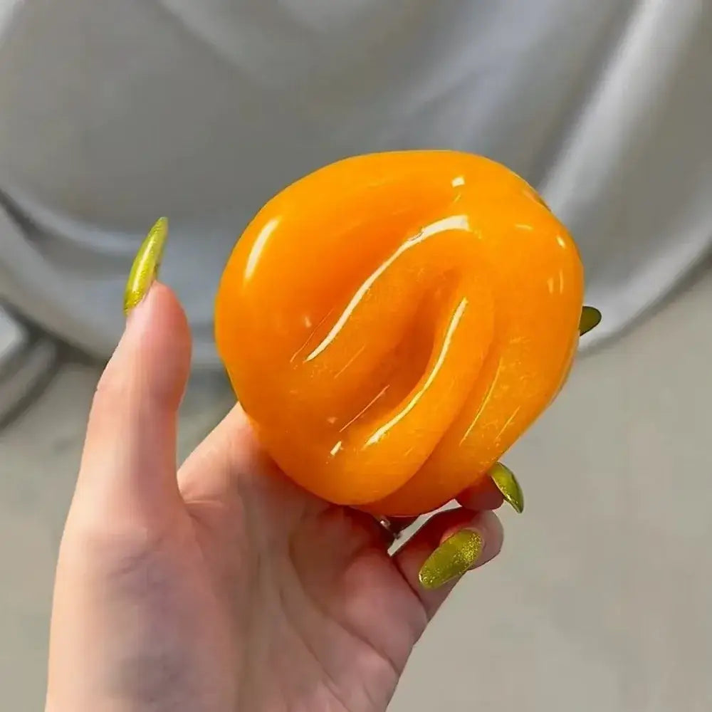 front view of vibrant orange slushy squishy with a smooth glossy texture and subtle ridged design