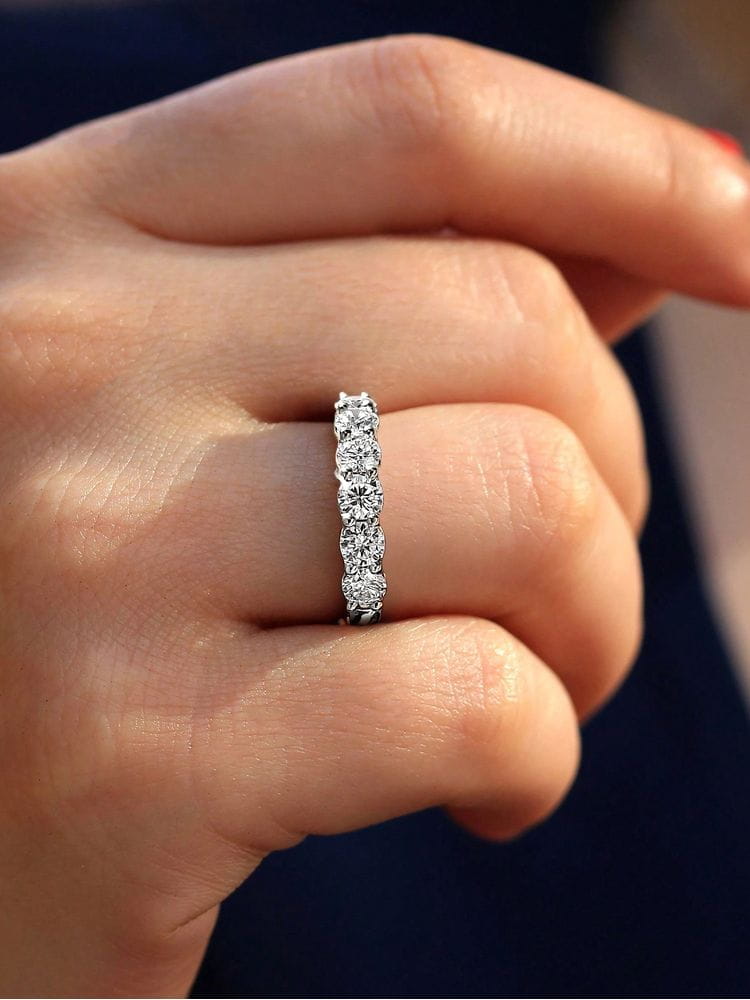 Sterling silver zircon wedding band for women featuring a sleek platinum eternity band design with five round-cut diamonds set in a continuous row.