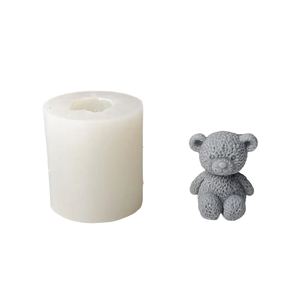 Gray textured bear candle mold next to a white cylindrical silicone mold for mini teddy bear candle making