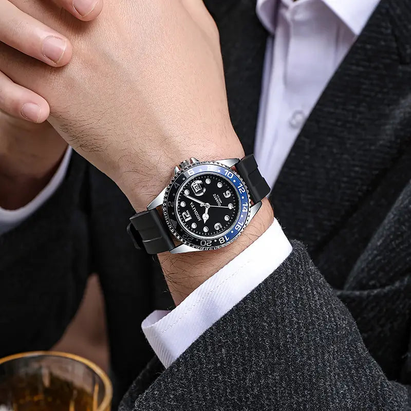 A quartz sport watch with a sleek black rubber strap, silver-toned case, blue bezel, and dark dial with white hour markers.