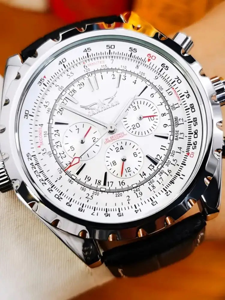Mechanical stainless steel men’s chronograph watch with silver-tone case, white dial featuring black and red markings, three subdials, and textured bezel.