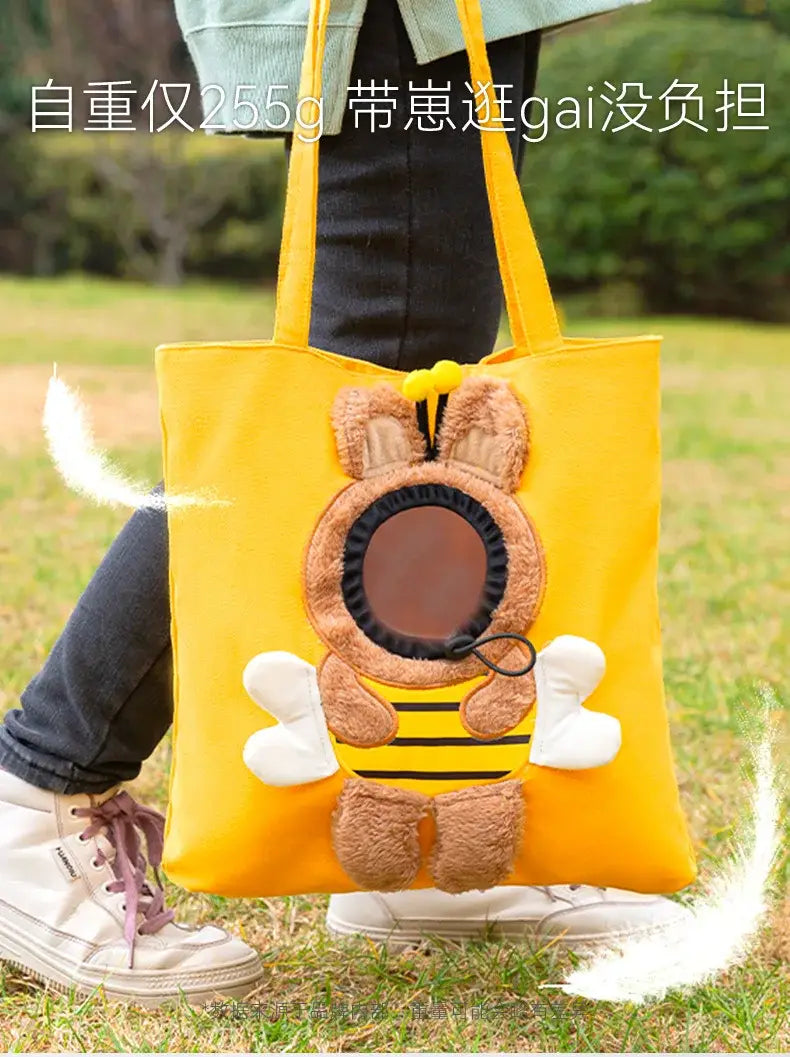 bright yellow canvas pet carrier bag tote featuring a plush bee design with brown fuzzy ears white wings and black stripes suitable for small dog and cat transport with mouth length consideration.