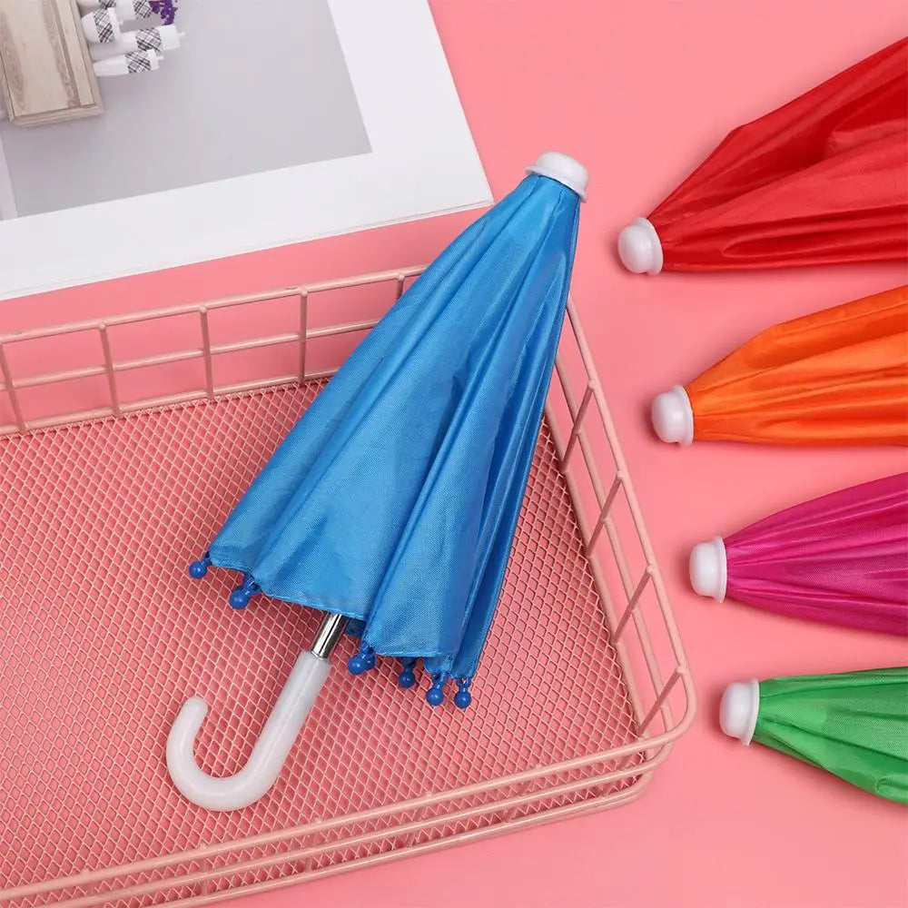 Mini doll umbrella BJD accessories featuring a vibrant blue canopy with small blue decorative beads along the edges and a white curved handle with matching white tip.