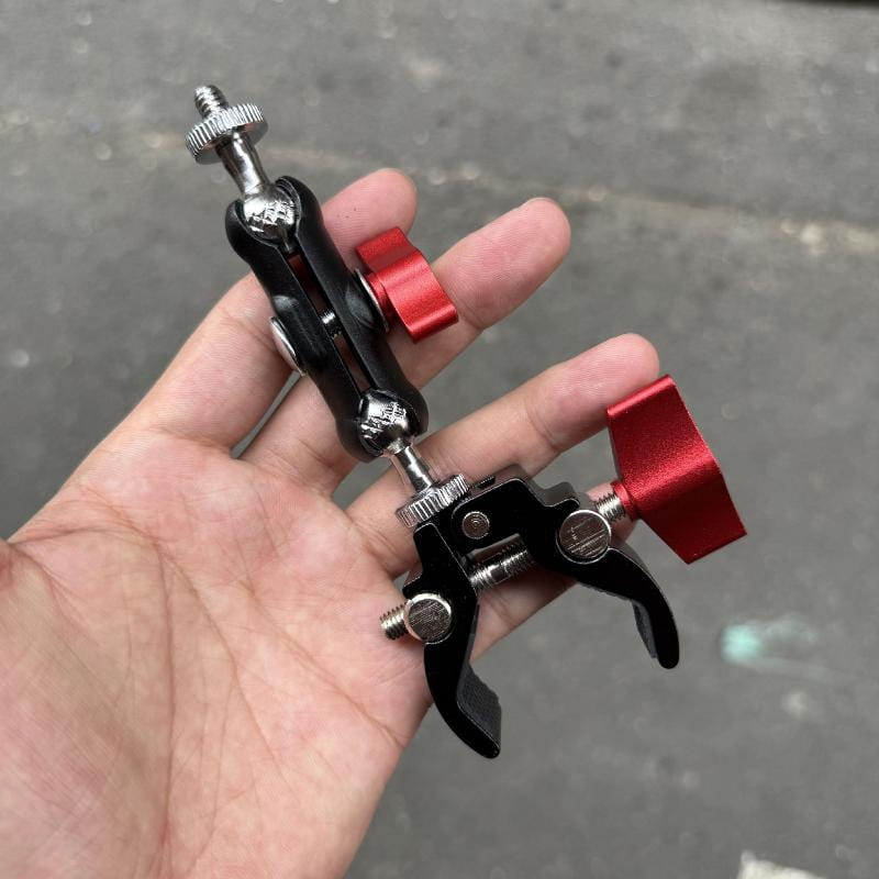 Black and red adjustable camera super clamp with metallic joints and knurled knobs in magic arm set for versatile mounting.