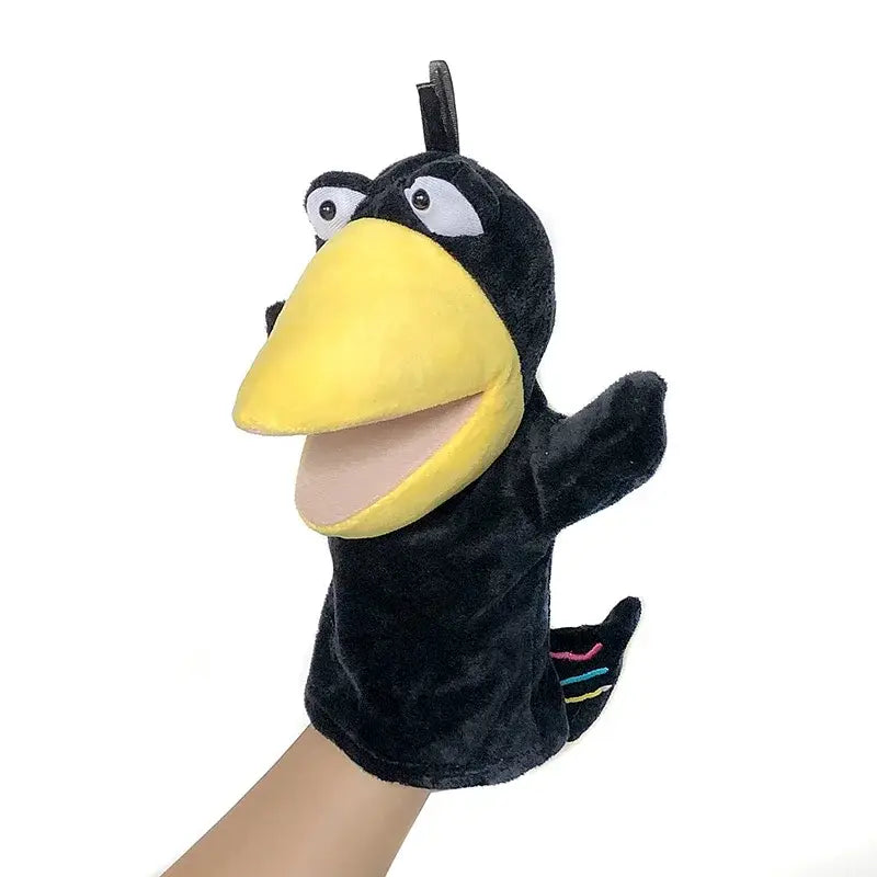 black plush hand finger puppet with a bright yellow beak white eyes and colorful striped tail detail designed as an educational baby toy from the lion elephant bunny collection.