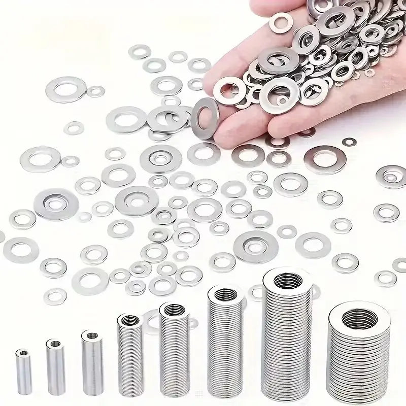 Hand holding a collection of shiny silver stainless steel flat washers and threaded inserts from an assorted kit of 1250 pieces.