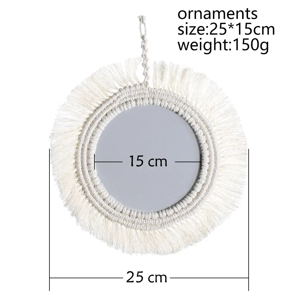 A circular boho macrame wall mirror with a white fringed frame and hanging loop suitable for living room home decor.