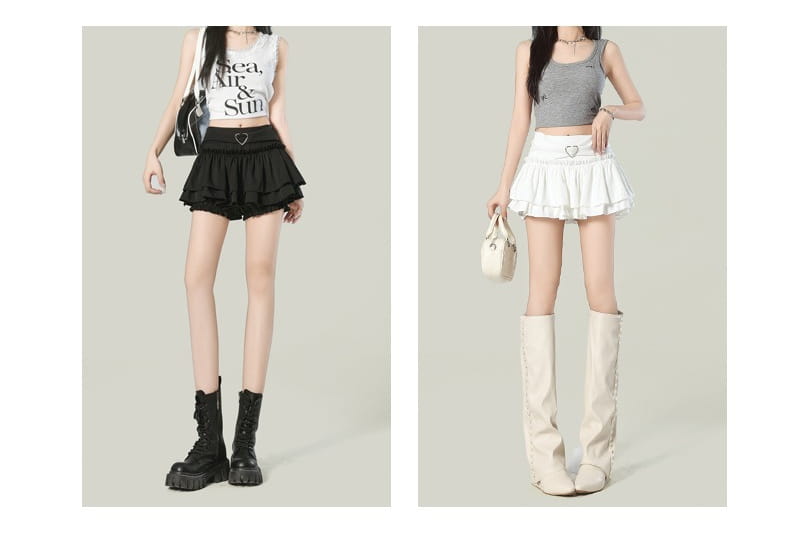 Black y2k ruffled high waist mini skirt featuring a heart-shaped belt buckle and layered detailing.