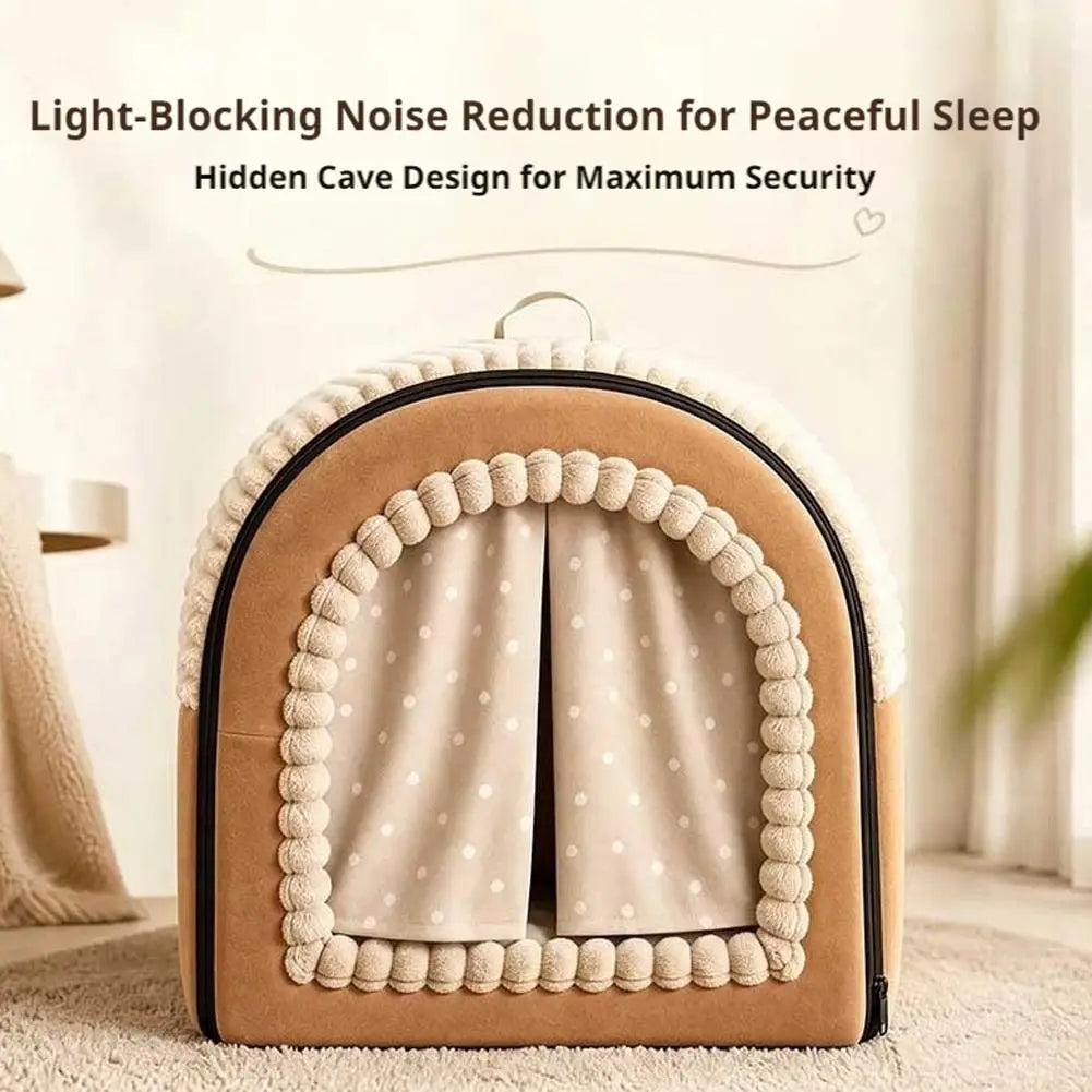 A cozy tan and cream pet bed cave made of washable warm cotton with a polka-dotted curtain, pom-pom trim, and soft plush material.